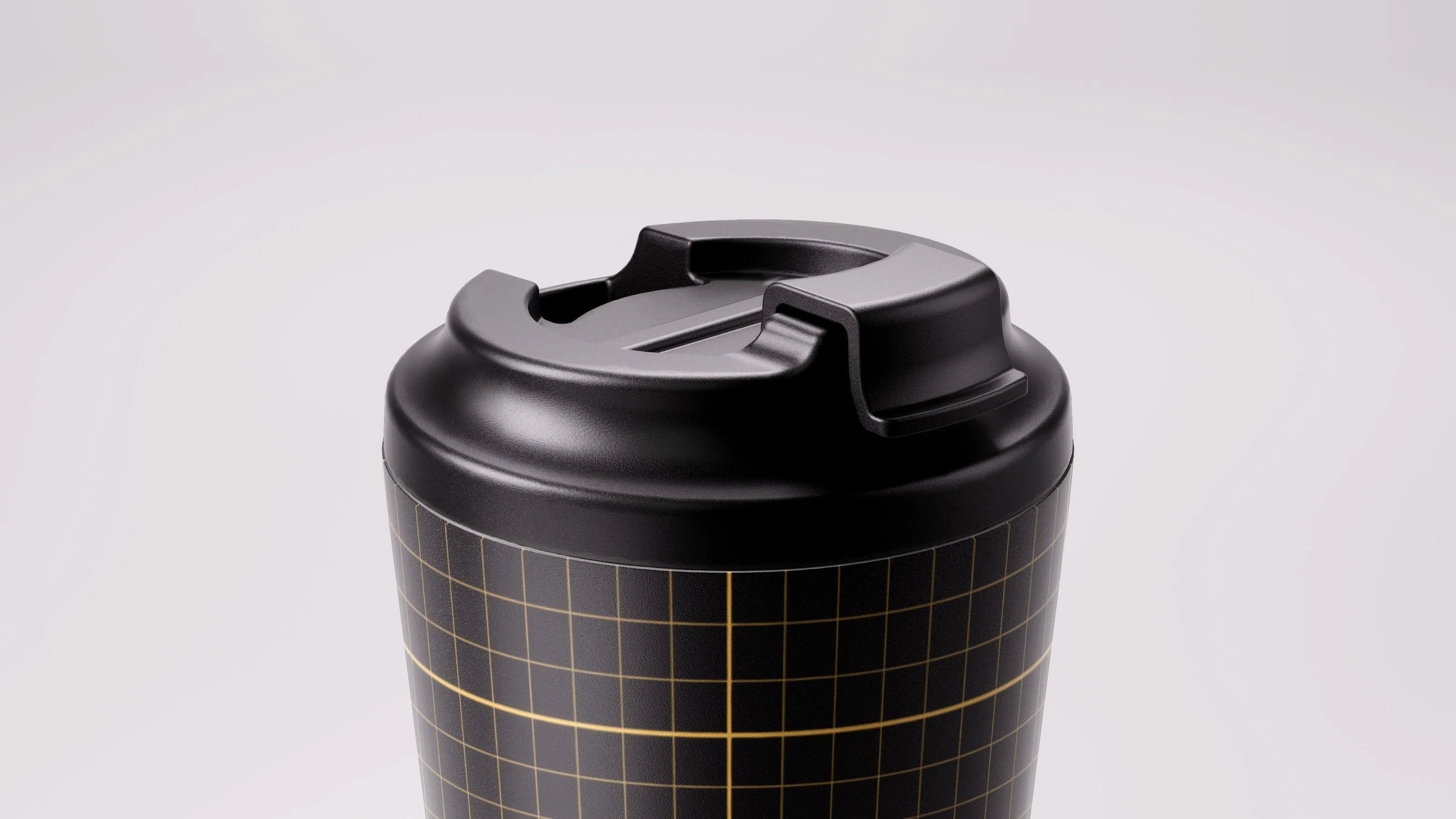 Close-up of the Fressko Camino cup lid on a black and gold grid-pattern cup