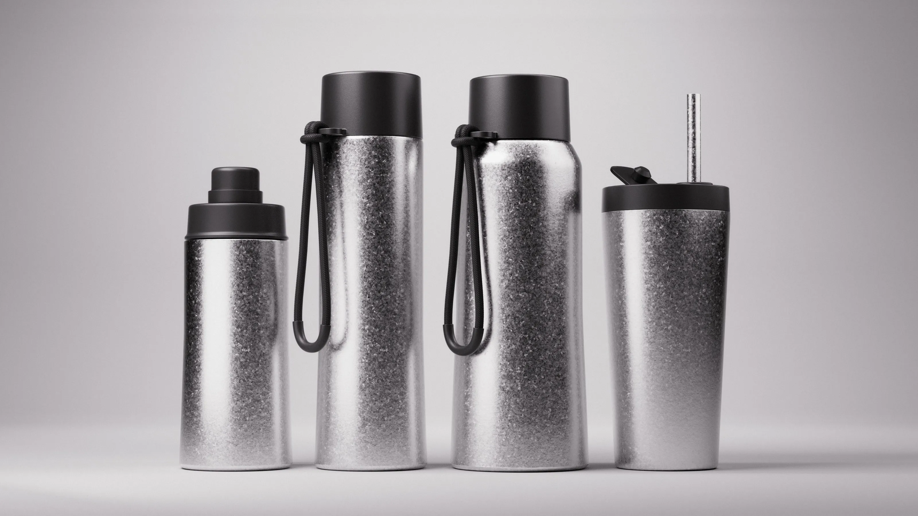The Fressko titanium-finish range: three drink bottles and a tumbler with straw, side by side